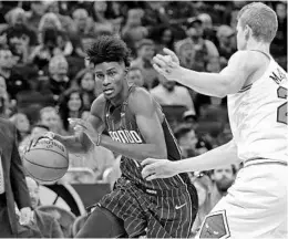  ?? JOHN RAOUX/ASSOCIATED PRESS ?? Magic rookie F Jonathan Isaac, left, rolled his ankle after blocking a shot in Saturday’s loss to the Nuggets. He has been listed as “out” for tonight’s game against the Warriors.