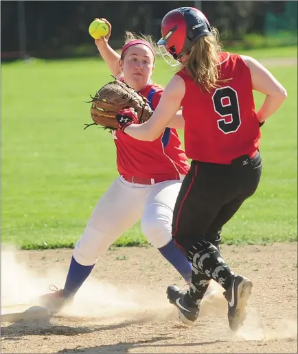  ?? Photo by Ernest A. Brown ?? Coventry’s Carly Furtado (9) slides into second base while Mount second baseman Esse Plouffe (left) attempts to turn a double play in the second inning of Wednesday’s Division I contest. Furtado and the Oakers cruised to a 12-1 victory in just five...