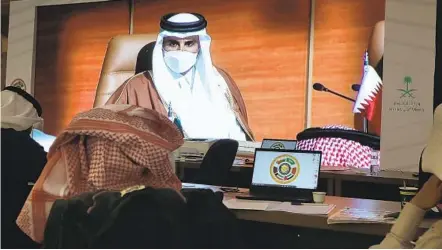  ?? AMR NABIL AP ?? Saudi journalist­s watch a screen showing Qatar’s Emir Sheikh Tamim bin Hamad Al Thani at the 41st Gulf Cooperatio­n Council (GCC) meeting in Saudi Arabia on Tuesday. Qatar’s emir arrived after Saudi Arabia announced it would end its yearslong embargo on the state.