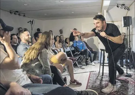  ?? Photograph­s by Nick Agro For The Times ?? THERE’S NOWHERE for show attendees to hide from comedian Thomas Dale at a Don’t Tell Comedy gig in Hollywood in May.