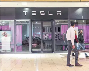  ?? LAURA BUCKHAM THE NEW YORK TIMES ?? A closed Tesla showroom in Dallas. After recently saying it would close most of its stores, Tesla now says it will close about half as many stores, but will raise prices on vehicles as a result.