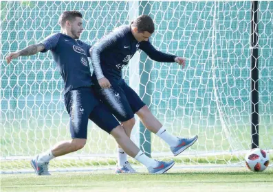  ?? — AFP ?? France’s Antoine Griezmann (R) vies with Lucas Hernandez during a training session at the Glebovets stadium in Istra.