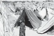  ?? PAMELA CONSTABLE/THE WASHINGTON POST ?? Makeshift tents put up by farmers fleeing the Taliban and drought cover a hillside outside Qala-e Nau, Afghanista­n.