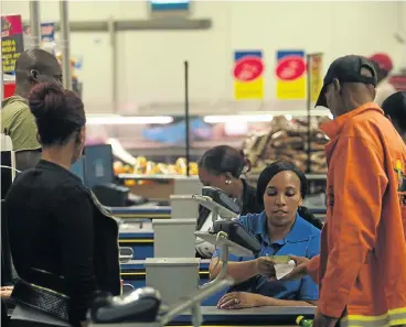  ?? Picture: KEVIN SUTHERLAND ?? CASH BACK: Customers pay for their goods at a Cambridge Food outlet, owned by Massmart, in central Johannesbu­rg. Massmart sales figures reflect growth of 8.4%, thanks partly to its partnershi­p with stokvels