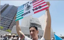  ?? Luis Sinco Los Angeles Times ?? ANDREW GARCIA, 22, holds a sign outside the ICE detention facility in downtown Los Angeles during a march for immigrant rights on June 30.