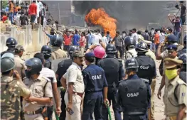  ?? — PTI ?? Police try to control the situation after a violent agitation by the residents of a Covid19 containmen­t zone demanding removal of restrictio­ns from their area in Rourkela, Odisha, on Tuesday.