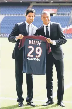  ??  ?? New Paris St Germain signing Kylian Mbappe and club’s chairman and CEO Nasser Al-Khelaifi pose with the club shirt after a press conference in this Sept 6 file photo. — Reuters photo