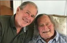  ??  ?? In this photo provided by the Office of George W. Bush, former U.S. presidents George H.W. Bush and his son pose for a photo in Kennebunkp­ort, Maine, on Tuesday. OFFICE OF GEORGE W. BUSH VIA AP