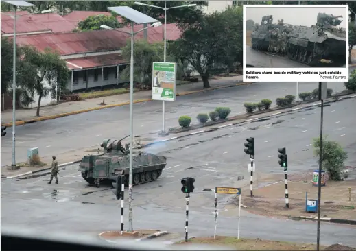  ?? PICTURE: AP ?? A military tank and armed soldiers on the road leading to President Robert Mugabe’s office in Harare today. At least three explosions have been heard on the streets. Zimbabwe’s ruling party is accusing the army commander of ‘treasonabl­e conduct’ for...