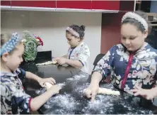  ??  ?? Nina Banon, left, and her sisters, Sara and Musya, bake challah bread for Shabbat in their home in Casablanca, Morocco.