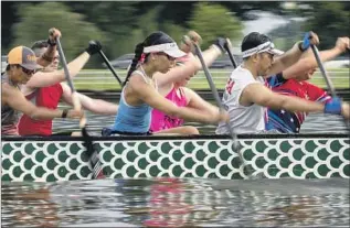  ?? ?? KIMBRIELL KELLY, center, paddles with the club at a practice in Washington. Dragon boats typically seat 20 paddlers. A drummer keeps the pace, and a steerer keeps the boat on course.