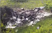  ?? RAMI SLUSH — THE ASSOCIATED PRESS ?? Israeli security stands around the wreckage of an F-16 that crashed in northern Israel on Saturday.