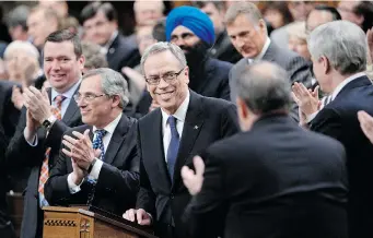  ?? ADRIAN WYLD/The Canadian Press ?? Minister of Finance Joe Oliver is given a standing ovation from his party as he arrives
to deliver the federal budget in the House of Commons on Tuesday.