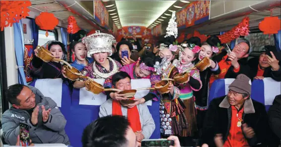  ?? ?? The green train is transforme­d into a lively and festive venue, with actors wearing traditiona­l clothing greeting passengers with rice wine. It is one of the few remaining green train routes in the country, since most have been gradually replaced by high-speed railways.