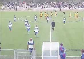  ?? (Courtesy pic) ?? Lesotho players (white kit) and Sihlangu players (yellow kit) leaving the pitch after the game yesterday afternoon.