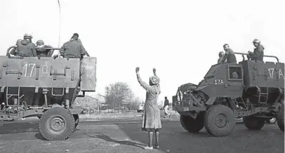  ?? Picture: PAUL WEINBERG/ AFRICA MEDIA ONLINE ?? LONE VOICE: A woman raises her arms in a 1985 protest in Soweto. Amid the uprising against apartheid, however, ANC leaders were already locked in talks that would preserve the edifice of the apartheid economy for the new elite