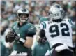  ?? MATT ROURKE — THE ASSOCIATED PRESS ?? Philadelph­ia Eagles quarterbac­k Carson Wentz looks to pass as offensive guard Brandon Brooks, back right, blocks Carolina Panthers defensive tackle Vernon Butler (92) during the first half of an NFL football game, Sunday.