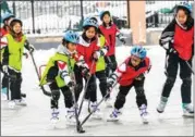  ?? WANG XIAOYING / SUN YUE ?? Pupils at a primary school in Hebei province play ice hockey.