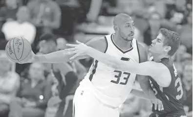  ?? RICK BOWMER/AP ?? The Suns’ Dragan Bender (right) guards Jazz center Boris Diaw during Utah’s 112-105 victory over Phoenix on Tuesday night.