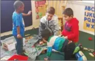  ?? PHOTO PROVIDED ?? Dutchess Day School seventh-grader Tassilo Adams and Astor Head Start students play with cars and trains.