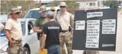  ?? —AFP ?? TEXAS: FBI agents confront protestors at the gate of the Arkema plant which received major damage from flooding caused by Hurricane and Tropical Storm Harvey in Crosby, Texas.