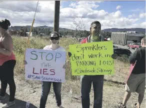  ?? GINGER MOYAH ?? Protesters in Burns Lake assemble on Saturday around 28 loaded trucks that sat idle in a store parking lot for the past few days.