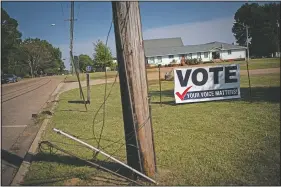  ??  ?? A banner urging residents to vote is displayed on the side of a street in Jackson, Miss. The opposition to Black votes in Mississipp­i has changed since the 1960s, but it hasn’t ended.