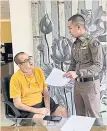  ?? ?? GOTCHA: Peter Coker Jr, 54, a citizen of St Kitts and Nevis, wanted by the US for fraud and stock manipulati­on, is arrested in a hotel room near Surin Beach in Thalang district of Phuket on Wednesday.