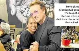  ??  ?? Bono gives Margarita Fores the hug of a lifetime after a delicious dinner at Grace Park.