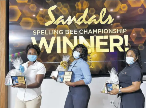  ??  ?? Champion speller Apphia Morgan (centre) is flanked by first runner-up Shantoy Blagrove (left) and Veronica Campbell (second runner-up.