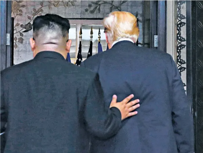  ??  ?? Donald Trump and Kim Jong-un leave after a signing ceremony at the Capella resort on Sentosa Island in Singapore yesterday