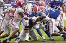  ??  ?? Florida quarterbac­k Emory Jones pushes his way past the Alabama defense for a 5-yard touchdown run Saturday in the Swamp. Alabama running back Brian Robinson (right) celebrates his TD reception Saturday against Florida with tight end Cameron Latu. Robinson carried 14 times for 75 yards and a score in addition to his receiving TD.