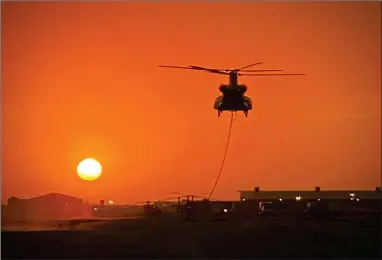  ?? PHOTO COURTESY OF SEQUOIA NATIONAL FOREST ?? A sunset view of a CH-47 Helitanker with a bucket at the Portervill­e Air Base on Saturday, October 3.