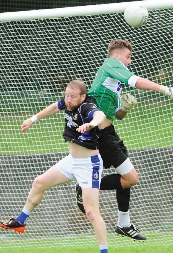  ?? Aidan Dullaghan ?? Dundalk Gaels goalkepper, John Burlingham punches the ball away from JP Rooney, Naomh Mairtin during the Group C SFC match in The Grove, Castlebell­ingham on Saturday night.