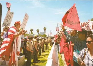  ?? Frank Wiese Associated Press ?? POLICE SEPARATE demonstrat­ors for and against Propositio­n 187 in Westwood in 1996. The measure was intended to deny schooling, nonemergen­cy healthcare and other public services to people here illegally.