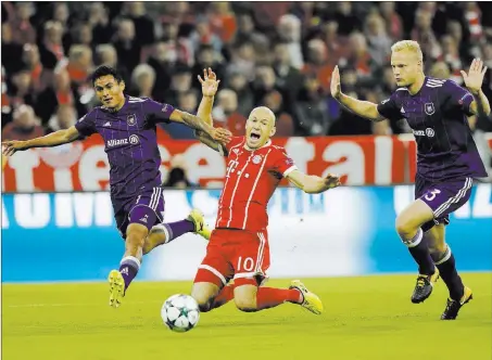  ?? Matthias Schrader ?? The Associated Press No question soccer is a no-hands sport as Bayern’s Arjen Robben, center, is chased by Anderlecht’s Olivier Deschacht, right, during a Champions League Group B match between FC Bayern Munich and RSC Anderlecht on Tuesday in Munich,...