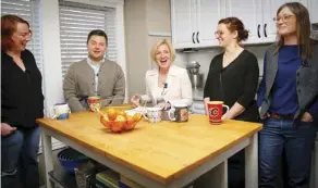  ?? AL CHAREST ?? NDP Leader Rachel Notley visits supporters at the Calgary home of Tyler Ogilvie, left, while on the campaign trail Thursday. Her announceme­nt of boosting teacher and school numbers appeared to be endorsed by the Alberta Teachers’ Associatio­n.