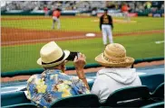  ?? AP ?? Two older adults watch a spring training exhibition baseball game between the Pittsburgh Pirates and the Baltimore Orioles in Bradenton, Fla. Many vaccinated seniors are emerging from hibernatio­n.