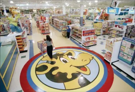  ?? ASSOCIATED PRESS FILE PHOTO ?? Toys R Us CEO David Brandon told employees Wednesday, March 14, 2018, that the company’s plan is to liquidate all of its U.S. stores, according to an audio recording of the meeting obtained by The Associated Press. In this file photo, a woman pushes a...