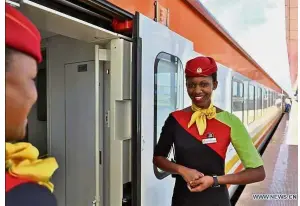  ??  ?? Welcome smile: Attendants waiting for passengers at the Mombasa Railway Station in Kenya. The Chinese-built Mombasa-Nairobi SGR of 480km has attained a ridership rate of over 95% while reducing the time between the cities by half to five hours. — Xinhua