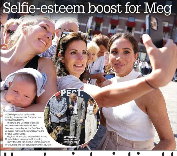  ?? ?? MEGHAN poses for selfies with beaming fans on a mini European tour with husband Harry.
The Duke and Duchess of Sussex touched down in Dusseldorf, west Germany, yesterday for the One Year To Go events marking the countdown to the Invictus Games 2023.
Meghan, 41, was also pictured with Harry, 37, as he talked to an armed forces dog.
Harry founded the Invictus Games, an event for wounded and sick service personnel, in 2014.