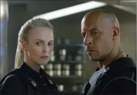  ?? UNIVERSAL PICTURES VIA AP ?? Charlize Theron, left, and Vin Diesel in “The Fate of the Furious.”