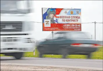  ?? The Associated Press ?? A billboard advertisin­g “Contract military service” is seen Thursday beside a highway outside Krasnodar, Russia. A campaign to replenish Russian troops is underway.