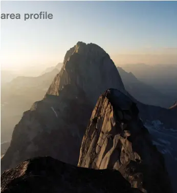  ??  ?? Left: Bugaboo Spire as seen from the summit of Snowpatch.
The rambling Kain route and Northeast Ridge are visible on either side