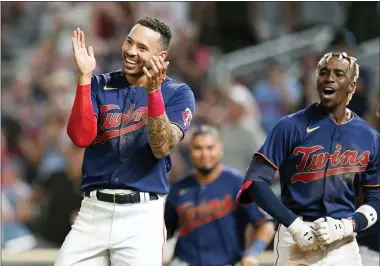  ?? ABBIE PARR — THE ASSOCIATED PRESS ?? Minnesota Twins’ Carlos Correa, left, and Nick Gordon, front right, celebrate after a walkoff two-run home run by Gio Urshela (not shown) during the bottom of the 10th inning of a baseball game against the Detroit Tigers in Minneapoli­s, Monday, Aug. 1, 2022.