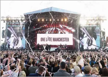  ??  ?? Music fans gather at the One Love Manchester benefit concert for the families of the victims of the May 22 Manchester terror attack, at Emirates Old Trafford on Saturday.