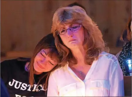  ?? PETE BANNAN — DIGITAL FIRST MEDIA ?? Natalie Elvin leans on the shoulder of her sister, Valerie Mason, during the Crime Victims Center of Chester County’s annual Candleligh­t Vigil and Memorial Service held at Central Presbyteri­an Church in Downingtow­n Thursday night. Elvin’s son, Julius Dale III, was murdered on May 27, 2016. The suspect’s trial begins in May.