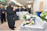  ?? AP ?? Shizue Takahashi, the widow of a subway worker killed in the March 20, 1995 sarin gas attack, prays after laying flowers on the stand set up at Kasumigase­ki subway station in Tokyo on Tuesday. —