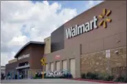  ?? TONY GUTIERREZ — THE ASSOCIATED PRESS FILE PHOTO ?? People walk in and out of a Walmart store, in Dallas.