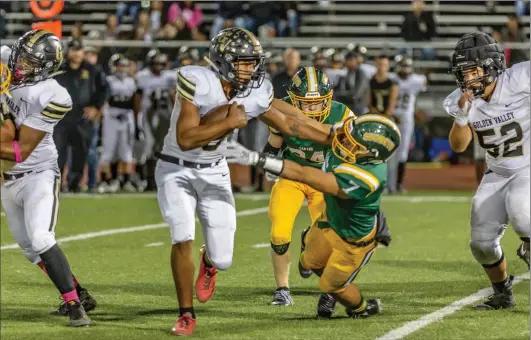  ?? Cory Rubin/The Signal (See additional photos at signalscv.com) ?? Golden Valley senior Johnathan Kaelin stiff-arms Shawn Gallagher in a league matchup at Harry Welch Stadium at Canyon High School on Friday night.